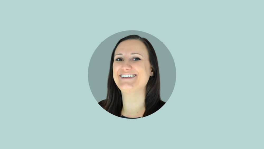 A woman with long dark hair smiling in a circular frame, set against a light teal background. This is Kayley Gaylor, an expert known for solving HR problems and advocating for data protection.