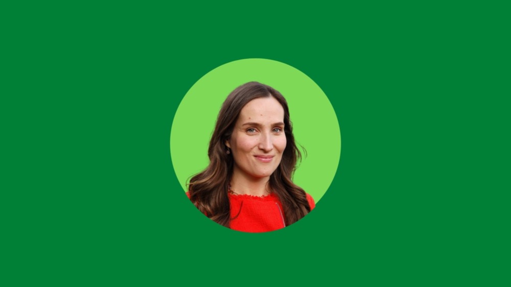 A woman with long brown hair wearing a red top is centered in a green circle, set against a larger green background, symbolizing the growth and independence associated with the great resignation.