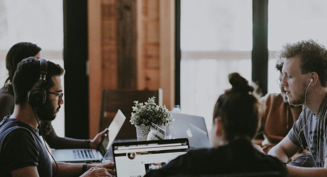 Young workers sitting around a table.