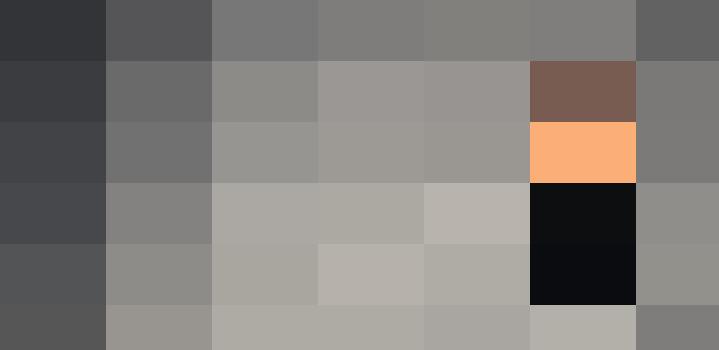 A man in a suit holding a teddy bear for work.