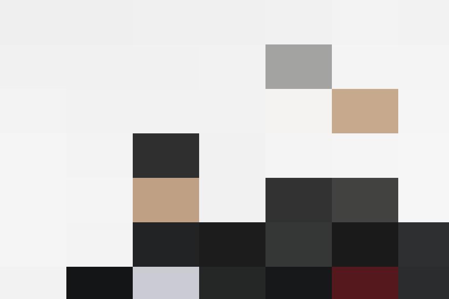 Two female graduates in graduation robes proudly holding their diplomas.