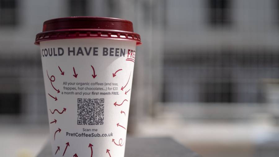 A takeaway coffee cup with a maroon lid, displaying a QR code and text, advertises Pret's subscription service for organic coffees, frappes, and hot chocolates, including a free first month.
