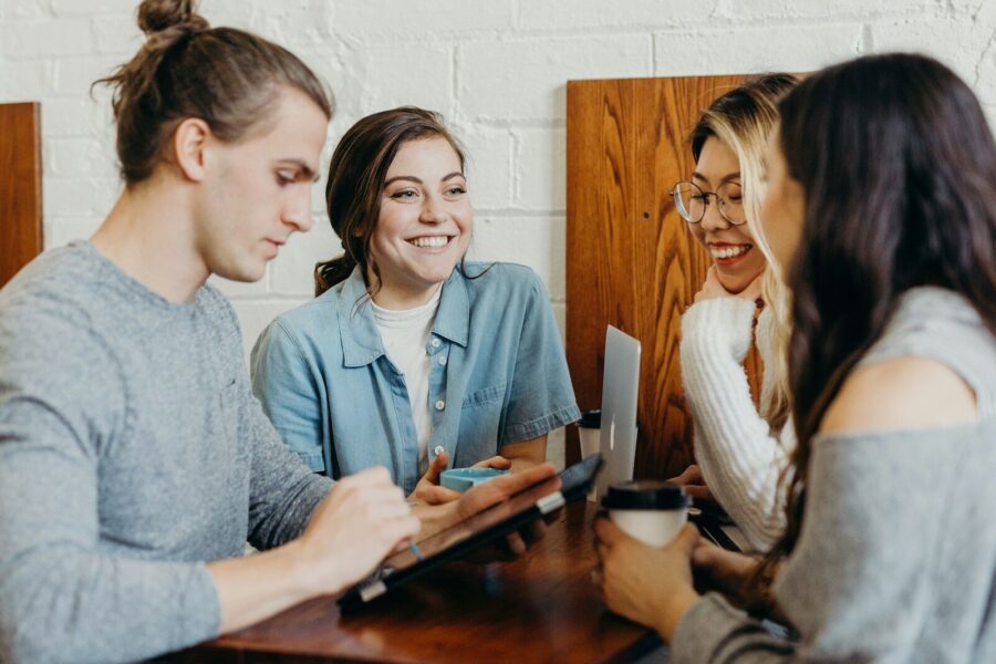 A group of young people around a table.