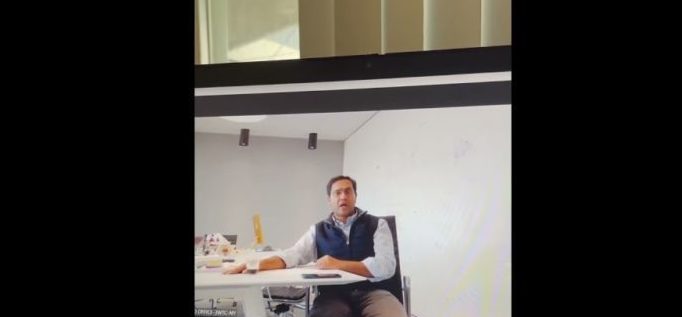 Vishal Garg at his desk, firing staff on Zoom