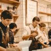 People working behind a cafe counter.