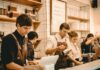 Employers turn to temporary staff as permanent hiring slowdown eases People working behind a cafe counter.