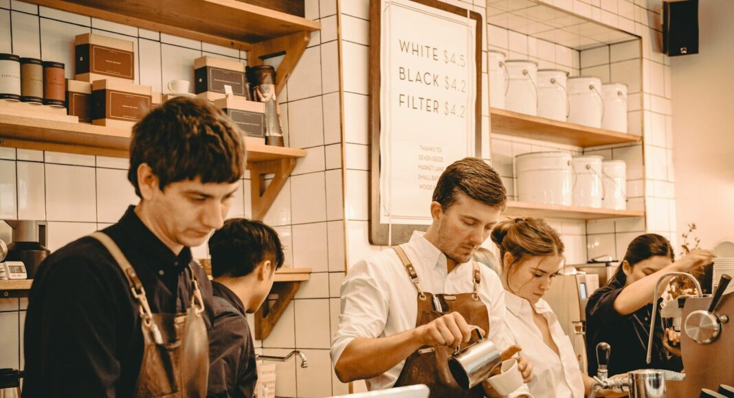 People working behind a cafe counter.