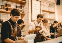 Employers turn to temporary staff as permanent hiring slowdown eases People working behind a cafe counter.