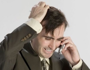 A man in a suit talking on a cell phone, discussing human resources strategies for diversity training.