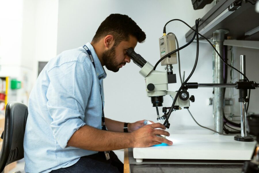 A man using a microscope.