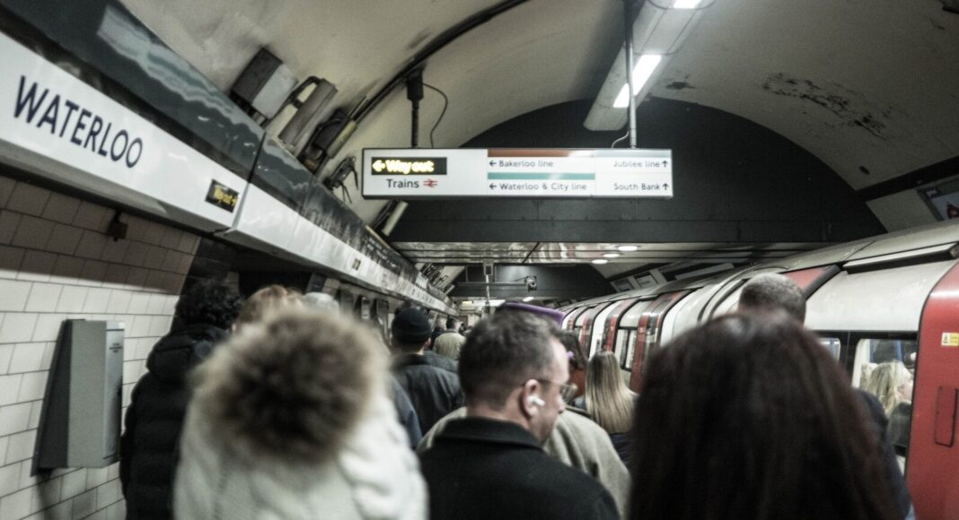 People waiting to board a Tube train in London.