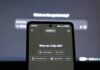 Workers ‘staying silent’ over harmful AI errors for fear of retaliation A smartphone displays an AI chatbot in front of a computer screen.
