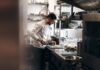 Iran conflict and rising costs push UK job vacancies to five-year low A chef working in a kitchen.