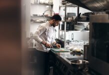Iran conflict and rising costs push UK job vacancies to five-year low A chef working in a kitchen.