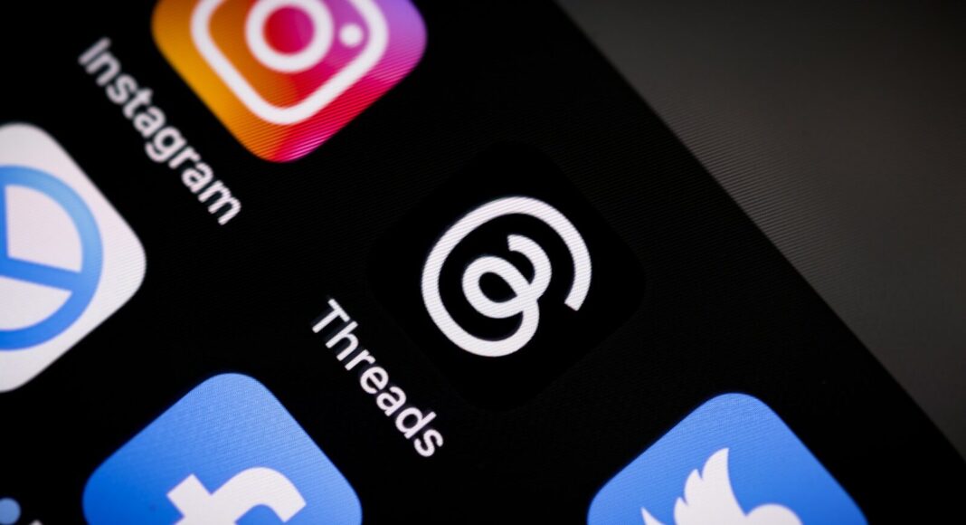 A close up of a mobile phone with social media icons.