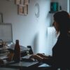 A woman working at a computer in a home office.