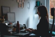 Women ‘face career setback’ risk with flexible working A woman working at a computer in a home office.