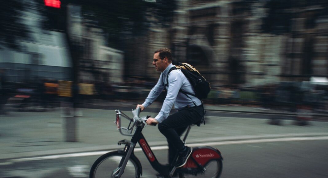 A man riding a bicycle to work.