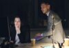 Low harassment reporting may hide workplace misconduct, employers warned A man sits on a desk while a woman beside him looks at a monitor, in a night setting at an office.