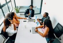 Pay decisions under strain as managers admit fairness doubts A group of people sitting around a white table.